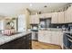Bright kitchen with black subway tile backsplash and granite countertops at 4710 69Th E Ct, Palmetto, FL 34221