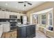Well-equipped kitchen featuring a central island, stainless steel appliances, and breakfast nook at 4710 69Th E Ct, Palmetto, FL 34221