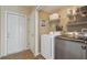 Spacious laundry room with washer, dryer, shelving and exterior access at 4710 69Th E Ct, Palmetto, FL 34221