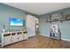 Stylish living room featuring a large TV, sliding barn door, and wood-look floors at 4710 69Th E Ct, Palmetto, FL 34221