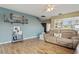 Cozy living room with a large sofa, wood floors, and blue accent wall at 4710 69Th E Ct, Palmetto, FL 34221