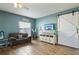 Comfortable living room with wood-look floors, a sofa, and a sliding barn door at 4710 69Th E Ct, Palmetto, FL 34221