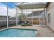 Relaxing screened-in pool area featuring lounge chairs and egg chair at 4710 69Th E Ct, Palmetto, FL 34221