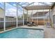 Inviting screened-in pool area with lounge chairs for relaxing and enjoying the outdoors at 4710 69Th E Ct, Palmetto, FL 34221