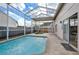 Relaxing screened-in pool area featuring lounge chairs, egg chair, and access to backyard at 4710 69Th E Ct, Palmetto, FL 34221