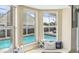 Bright bay window seat overlooking a sparkling in-ground pool at 4710 69Th E Ct, Palmetto, FL 34221