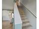 Carpeted staircase with white railing ascends to the upper level, adding an elegant touch to the home's interior at 4710 69Th E Ct, Palmetto, FL 34221