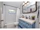 Charming bathroom with a blue vanity, subway tile walls, and black and white tiled floors at 4925 16Th N Ave, St Petersburg, FL 33710
