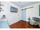 This bedroom features hardwood floors, a barn door, a flat screen TV, and comfortable chair at 4925 16Th N Ave, St Petersburg, FL 33710