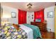 Inviting bedroom with red curtains, wood floors, and a comfortable bed at 4925 16Th N Ave, St Petersburg, FL 33710