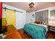 Cozy bedroom featuring warm wood floors, pink ceiling, and a decorative wall panel at 4925 16Th N Ave, St Petersburg, FL 33710