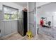 Cozy kitchen with stainless steel refrigerator, and gray cabinets, leading to the living room at 4925 16Th N Ave, St Petersburg, FL 33710