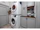 Bright laundry room featuring a stacked washer and dryer, and gray cabinets at 4925 16Th N Ave, St Petersburg, FL 33710