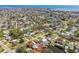 Aerial view showcasing neighborhood with waterway access, mature trees, and pools with highlighted property boundaries at 5050 Venetian Ne Blvd, St Petersburg, FL 33703