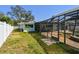 Backyard view showcasing pool and screened-in patio, ideal for outdoor entertaining and relaxation at 5050 Venetian Ne Blvd, St Petersburg, FL 33703
