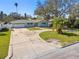 Charming single-story home with a circular driveway and well-maintained landscaping at 5050 Venetian Ne Blvd, St Petersburg, FL 33703