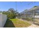 Fenced backyard with a screened-in pool area and lush green grass at 5050 Venetian Ne Blvd, St Petersburg, FL 33703