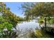 Picturesque waterfront view with lush greenery, calm water, and a charming wooden dock at 5050 Venetian Ne Blvd, St Petersburg, FL 33703