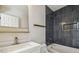 Bathroom with sleek vanity and dark tiled shower featuring gold fixtures at 520 Wheaton Trent Pl, Tampa, FL 33619