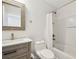 Bathroom featuring a wood vanity, woven mirror, tub-shower combo, and neutral tones at 520 Wheaton Trent Pl, Tampa, FL 33619
