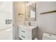 Modern bathroom features a white vanity with gold fixtures and a decorative mirror at 520 Wheaton Trent Pl, Tampa, FL 33619