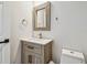 Stylish bathroom with a wooden vanity, framed mirror, and contemporary fixtures at 520 Wheaton Trent Pl, Tampa, FL 33619