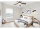 Bright bedroom with a wooden bed frame, stylish décor, and natural light from the window at 520 Wheaton Trent Pl, Tampa, FL 33619
