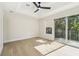 Bedroom with natural light, tray ceiling, ceiling fan, and balcony access at 520 Wheaton Trent Pl, Tampa, FL 33619