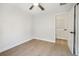 Neutral-toned bedroom with light wood floors, a ceiling fan, and a closet at 520 Wheaton Trent Pl, Tampa, FL 33619
