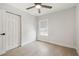 Bedroom with a ceiling fan, light wood floors, and a window for natural light at 520 Wheaton Trent Pl, Tampa, FL 33619