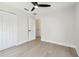 Spacious bedroom featuring modern ceiling fan, wood floors and closet at 520 Wheaton Trent Pl, Tampa, FL 33619