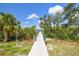 Scenic dock pathway leading to serene waters under a bright sky, perfect for waterfront living at 520 Wheaton Trent Pl, Tampa, FL 33619