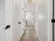 Bright hallway features light wood floors and white doors with black hardware at 520 Wheaton Trent Pl, Tampa, FL 33619