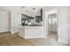 Bright modern kitchen with an island, stainless steel refrigerator and light filled breakfast nook at 520 Wheaton Trent Pl, Tampa, FL 33619
