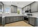 A well-equipped kitchen featuring stainless steel appliances and gray cabinetry with modern hardware at 520 Wheaton Trent Pl, Tampa, FL 33619