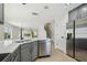 Open kitchen with stainless appliances, white countertops, gray cabinets, and access to the living area at 520 Wheaton Trent Pl, Tampa, FL 33619