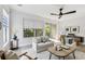 Cozy living room featuring modern furniture, a ceiling fan, and a sliding door leading to a balcony at 520 Wheaton Trent Pl, Tampa, FL 33619