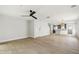Open-concept living room with hardwood flooring, ceiling fan, and modern light fixtures at 520 Wheaton Trent Pl, Tampa, FL 33619