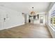 Open-concept living area featuring hardwood floors flowing into a modern kitchen with stainless steel appliances at 520 Wheaton Trent Pl, Tampa, FL 33619