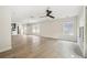 Open living area with hardwood floors, a ceiling fan, and large windows offering plenty of natural light at 520 Wheaton Trent Pl, Tampa, FL 33619