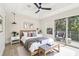 Serene main bedroom with balcony, tray ceiling, ceiling fan, and calming decor at 520 Wheaton Trent Pl, Tampa, FL 33619
