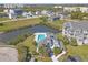Waterfront home with an outdoor pool, lush landscaping, and private access to a community pond at 5722 Biscayne Ct # 308, New Port Richey, FL 34652