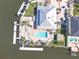 Waterfront property featuring a pool, boat dock, and lush landscaping with palm trees at 5722 Biscayne Ct # 308, New Port Richey, FL 34652