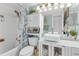 Stylish bathroom with a modern vessel sink, decorative shelving, and a shower-tub combination at 5722 Biscayne Ct # 308, New Port Richey, FL 34652