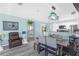 Bright dining area with a decorative Tiffany-style light fixture and a view to the modern kitchen at 5722 Biscayne Ct # 308, New Port Richey, FL 34652