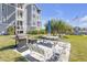 Condo common area with grilling area, picnic table, benches and manicured lawn at 5722 Biscayne Ct # 308, New Port Richey, FL 34652
