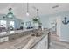 Open-concept kitchen featuring granite countertops, stainless steel appliances, and bright overhead lighting at 5722 Biscayne Ct # 308, New Port Richey, FL 34652