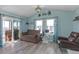 Inviting living room with sliding glass doors to the balcony and nautical decor at 5722 Biscayne Ct # 308, New Port Richey, FL 34652
