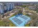 Tennis courts sit in the middle of a community with condos, apartments, and beautiful mature shade trees at 5722 Biscayne Ct # 308, New Port Richey, FL 34652