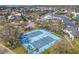 Aerial view of tennis courts available in a beautiful waterfront community surrounded by palms and oak trees at 5722 Biscayne Ct # 308, New Port Richey, FL 34652